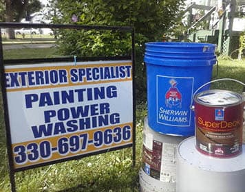 Exterior Specialist sign beside Sherwin-Williams paint products